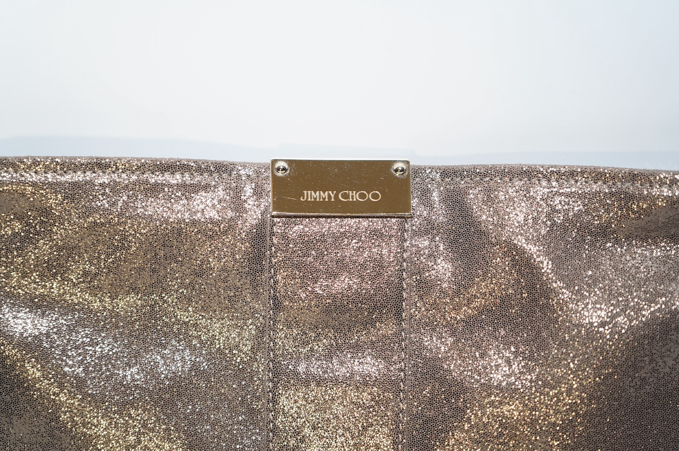 A Jimmy Choo metallic gold clutch bag, with dust bag